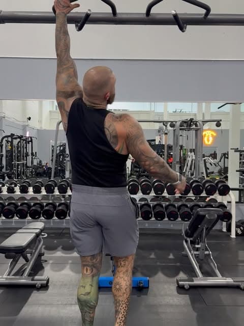 Kyle Mamane training on a cable station