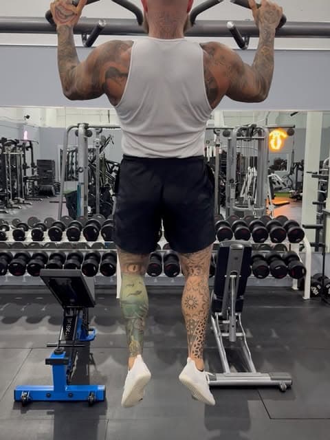 Kyle Mamane performing a pull-up in the gym