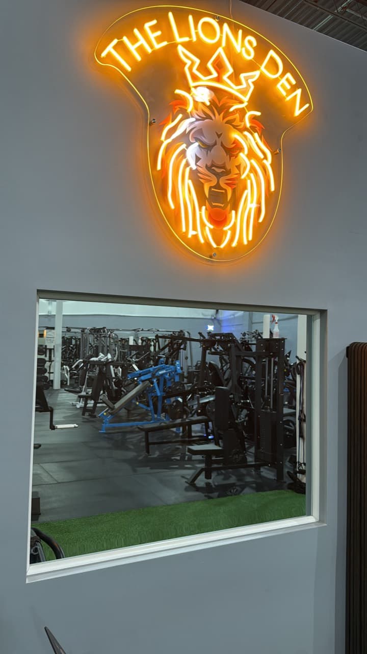 The illuminated Lions Den sign overlooking the training floor