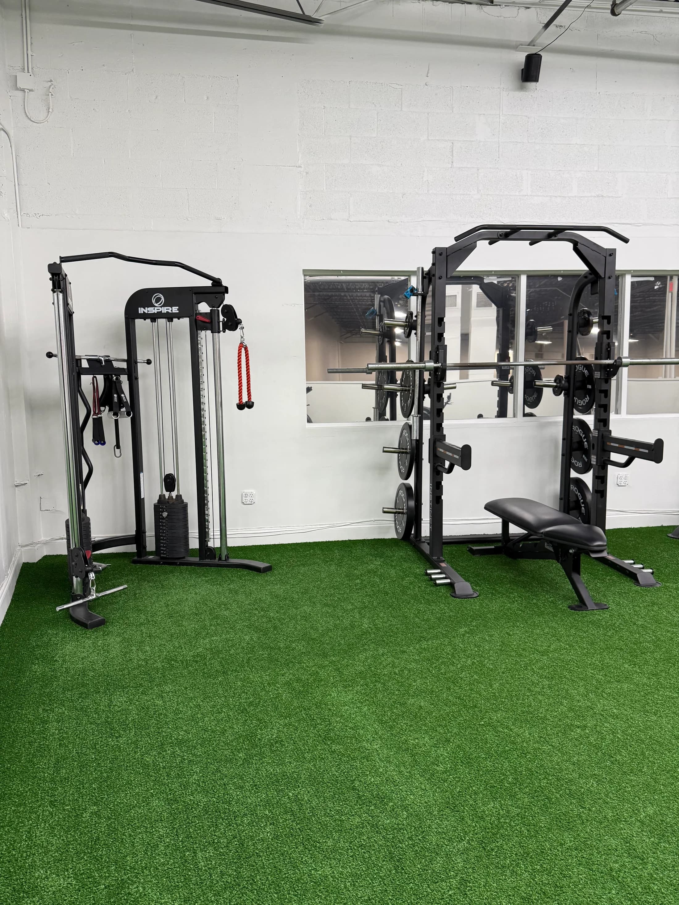 The strength equipment and turf in the real Lions Den gym